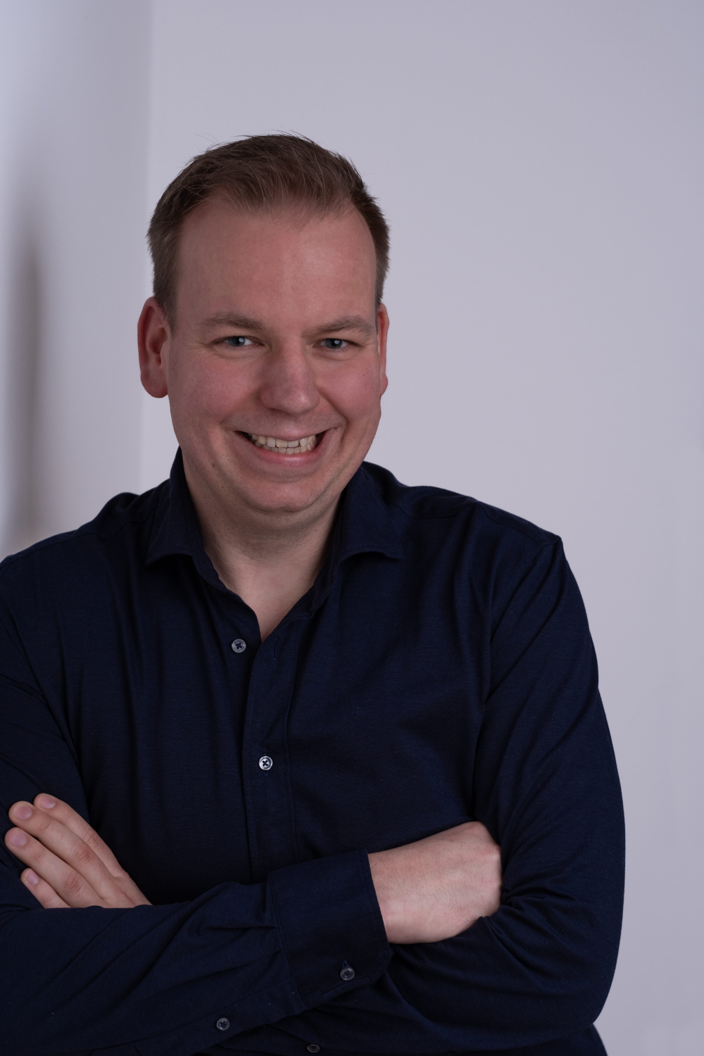 Mike Slinkman standing in front of a light background